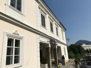a white building with a door in front of it at Apartment Lakeside in Salzburg