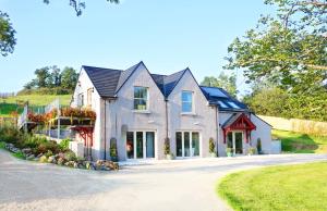 a large house with a driveway at Cuilcagh Luxury Apartment in Enniskillen