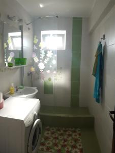 a bathroom with a toilet and a sink and a shower at Apartament Lupu - Eforie Nord in Eforie Nord +9 photos