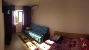a small bedroom with a bed and a window at Apartament Lupu - Eforie Nord in Eforie Nord