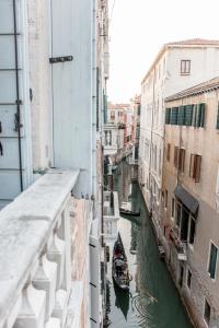 a view of a canal in a city with a boat at CA FOSCARINI 1 in Venice