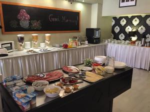 a buffet of food on a table in a kitchen at Hotel Gloria Budapest City Center in Budapest