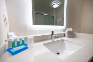 a white bathroom with a sink and a mirror at Holiday Inn Express & Suites - Southaven Central - Memphis, an IHG Hotel in Southaven