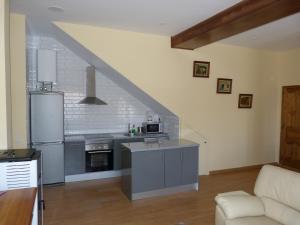 a large kitchen with a staircase in a house at Apartamento Zapatero in Trabanca