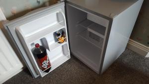 an open refrigerator with a bottle of soda in it at Annie's Guest House in South Shields