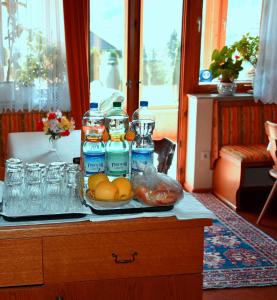 a tray with bottles of water and a plate of oranges at Privatzimmer Lasshofer in Mauterndorf