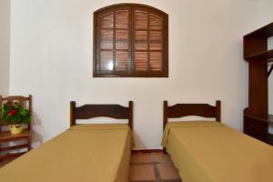 Cama ou camas em um quarto em Pousada Tanto Mar