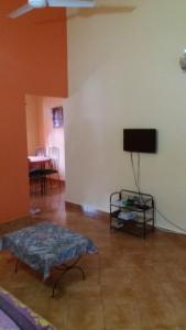 a living room with a flat screen tv on a wall at Lotus Benaulim - Beach Apartment in Benaulim