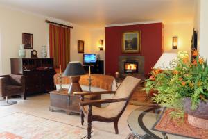 a living room with a living room with a fireplace at Quinta Da Cova Do Milho in Santo António da Serra