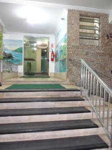 a staircase in a building with a door and a wall at Apartamento São Vicente in São Vicente