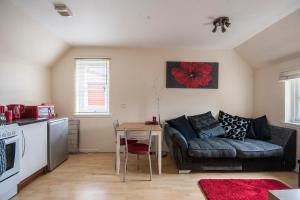 a living room with a couch and a table at 8 Varis Apartments in Forres