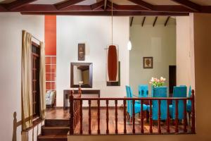 a dining room with blue chairs and a table at Villa Lemon Court in Nuwara Eliya