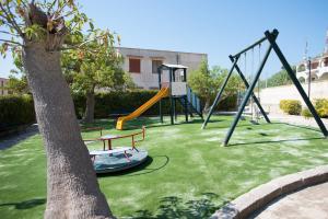 a park with a playground with a swing at Residence Capo San Marco & Renella in Sciacca