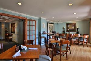 a dining room with wooden tables and chairs at The Kennebunk Inn in Kennebunk