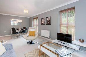 a living room with a couch and a tv at Liberty Suite in Portishead