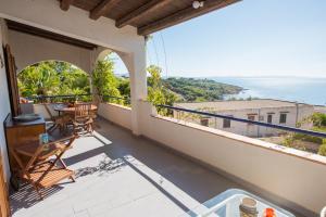 a balcony with a table and a view of the ocean at Residence Capo San Marco & Renella in Sciacca