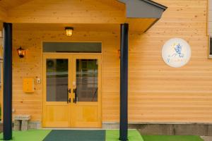 a wooden house with a door and a sign on it at Guesthouse Hoshizora no Akari in Matsumoto +98 photos