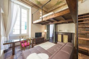 a living room with a couch and a desk at Charming Genova | Residenza d'epoca in Genoa