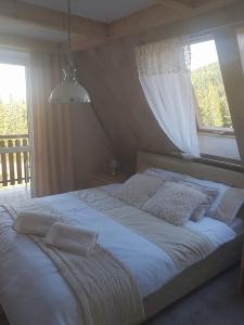 コシチェリスコにあるApartament Palisanderのベッドルーム1室(大型ベッド1台、窓付)
