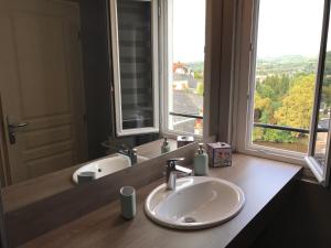 a bathroom with a sink and a large window at Les Maisons du Périgord in Terrasson-Lavilledieu +46 photos