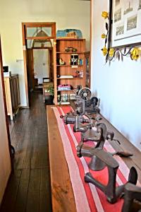 a room with a bunch of tools on a wooden floor at Pousada Estação do Trem in São João del Rei