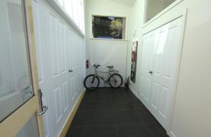 a bike parked in a hallway with white doors at Riverwalk B&B in Robigana