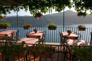 a table with chairs and a view of the water at Apartment Castel Gandolfo in Castel Gandolfo