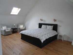 Un pat sau paturi într-o cameră la Huize Ewoud