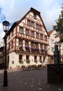a building with tables and chairs in front of it at Zum Fehmelbauer in Karlstadt