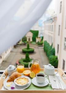 a tray of breakfast food on a table with a view at Italyanskaya 29 in Saint Petersburg