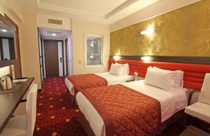 Postel nebo postele na pokoji v ubytování Marwa Hotel