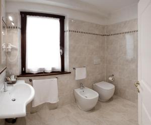 a white bathroom with a sink and a toilet at La Portella in Fabriano +19 photos