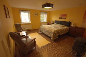 a bedroom with a bed and a desk and a chair at Virulase Holiday Home in Toila