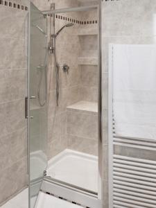 a shower stall with a glass door in a bathroom at La Portella in Fabriano