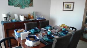a dining room table with blue dishes on it at Casa das Conchas in Ericeira