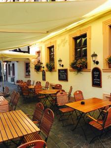 an empty restaurant with wooden tables and chairs at Zum Fehmelbauer in Karlstadt +20 photos