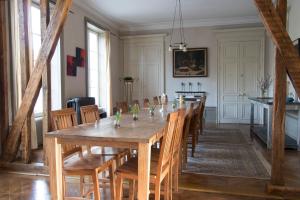 a dining room with a long wooden table and chairs at Joie de Vivre in Doulevant-le-Château