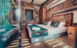 a bedroom with a bed and a glass shower at Keros Blue - Luxury in Wilderness in Kalliópi
