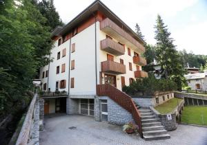 a building with a staircase in front of it at Residence Primula in Madesimo
