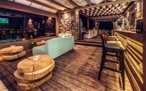 a restaurant with tables and chairs and a bar at Keros Blue - Luxury in Wilderness in Kalliópi