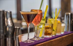 a table with three drinks on a purple tray at Keros Blue - Luxury in Wilderness in Kalliópi