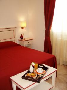 a hotel room with a tray of food on a bed at Alla Corte Del Picchio Room & Breakfast in Castel Guelfo di Bologna