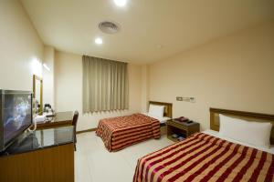 Postel nebo postele na pokoji v ubytování Songshan Hotel