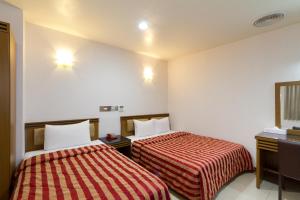 Postel nebo postele na pokoji v ubytování Songshan Hotel