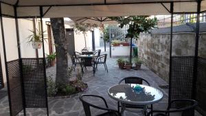 an outdoor patio with tables and chairs and an umbrella at Florence Stadium B&B in Florence