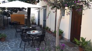 a patio with two tables and an umbrella at Florence Stadium B&B in Florence