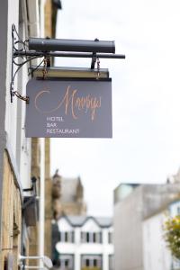 a sign for a hotel next to a building at Mannings Hotel in Truro