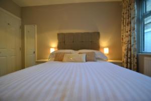 a bedroom with a large white bed with two pillows at Charming 1 bed riverside apartment in Chester