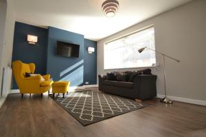a living room with a couch and a yellow chair at Charming 1 bed riverside apartment in Chester