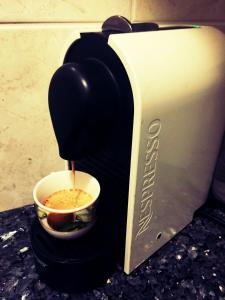 a coffee maker is making a cup of coffee at Apartment "Birgit" Sonnleitn/Nassfeld in Sonnenalpe Nassfeld